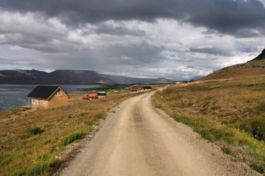 Winding gravel road next to Hvalfjordur fiord in Iceland clipart