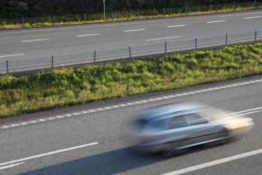 Car in motion on European road E18 in Norway. Highway traffic. clipart