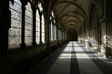 Mysterious abbey. Interior - corridor of cathedral in Burgos, Castilia, Spain. Old Catholic landmark listed on UNESCO World Heritage List. clipart