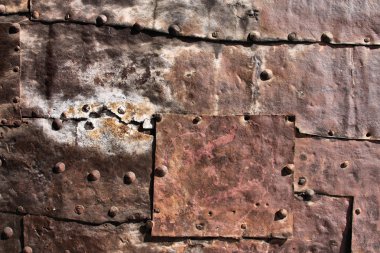 Vintage rusty iron background - metal plates with bolts. Grunge texture. clipart