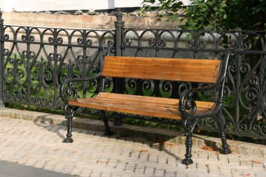 Single bench in a park in Pecherska Lavra, Kiev, Ukraine clipart