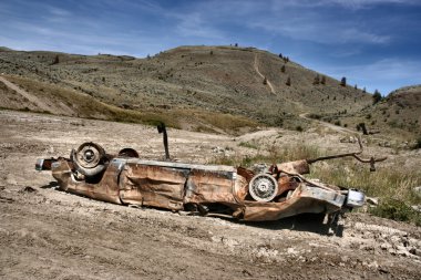 Crashed, rusty car in desert. Photo taken near Kamloops, British Columbia, Canada (North America). clipart
