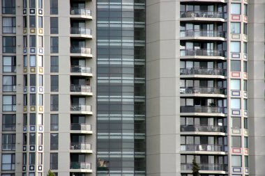 Front facade of residential condos skyscraper. Abstract modern architecture. clipart