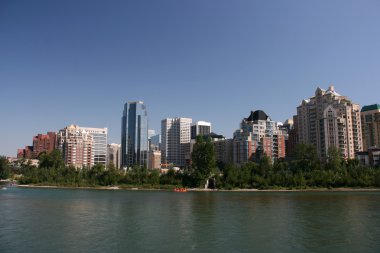 Calgary downtown skyline with Bow River. Modern skyscrapers architecture. clipart