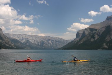 Lake Minnewanka in Rocky Mountains of Canada. Banff National Park, Alberta. Kayaking. clipart