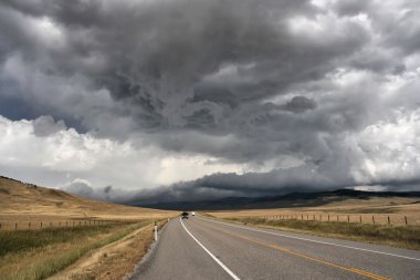 Prairie road in Alberta, Canada. Imminent storm. clipart