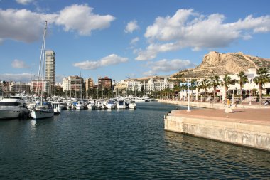 Marina yachts and motorboats in Alicante, Comunidad Valenciana, Spain. On the right: Saint Barbara Castle. clipart