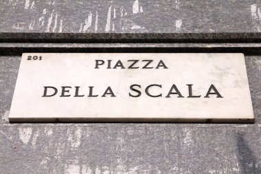 Milan, Italy. Square name sign, old architecture detail - famous Piazza Della Scala. clipart