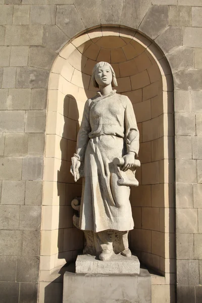 Warsaw, Poland. Statue in Palace of Culture and Science facade - sculpture of Chinese woman.