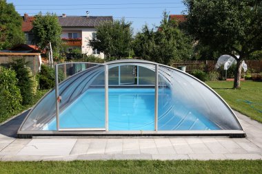 Private outdoor covered swimming pool in backyard in Austria. clipart