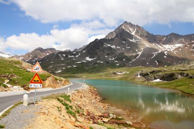 Italy. Lake at Gavia Pass in Stelvio National Park. Ortler Alps. In background: Corno dei Tre Signori peak, 3360m high. clipart