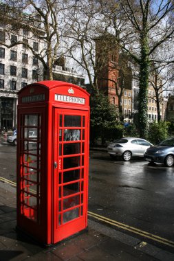 Typical London phone booth on Soho Square - symbol of Great Britain. clipart