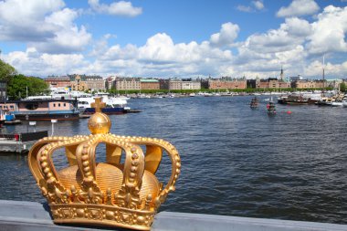 Stockholm, Sweden. Skeppsholmsbron (Skeppsholm Bridge) with its famous gilded crown and Strandvagen in background. clipart
