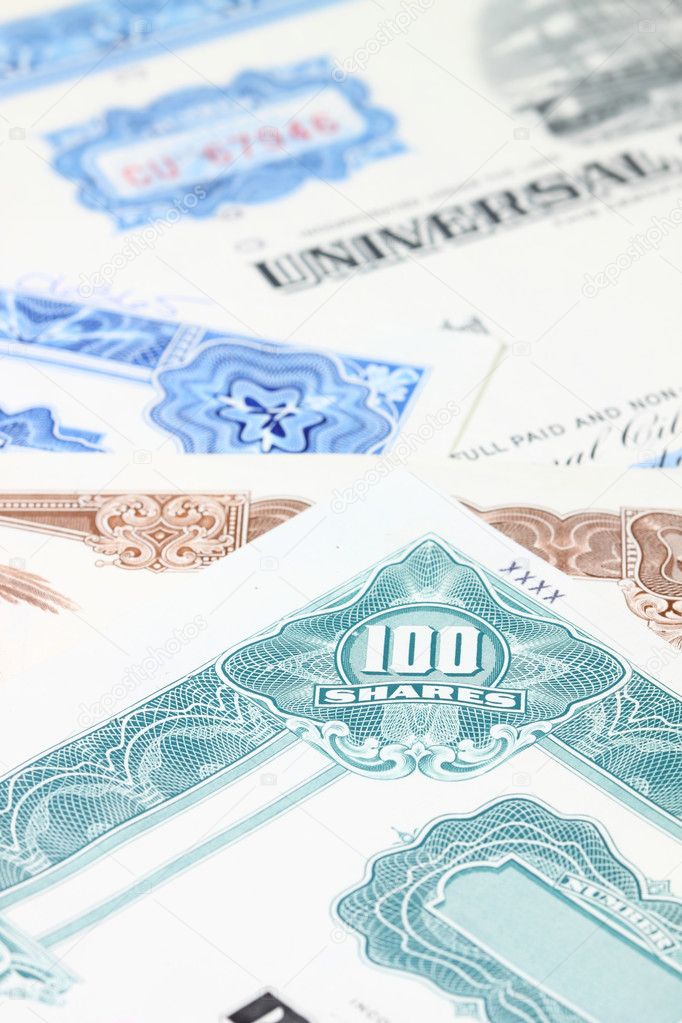 Stock market collectibles. Old stock share certificates from 1950s-1970s (United States). Vintage scripophily objects (obsolete) with shallow depth of field (fo