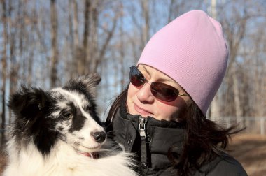 Young woman with pink hat and her shetland sheepdog clipart