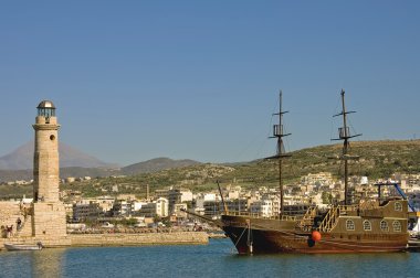 View of the harbor of Chania, Crete, Greece with the lighthouse and its typical greek schooner clipart