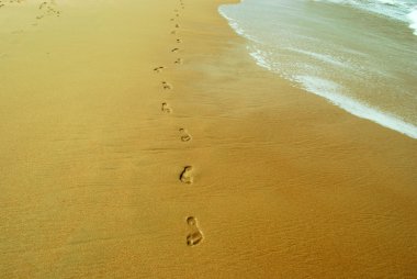 Foot steps on a sand clipart