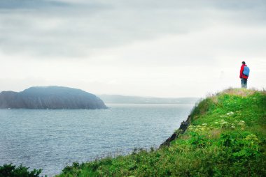A man on a cliff clipart