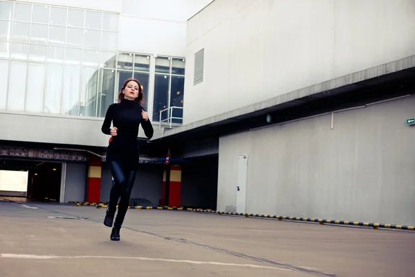 stock image Woman runs away from a building downtown