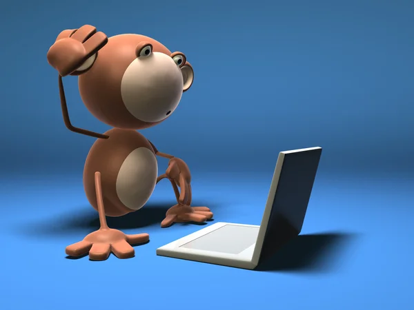 Mono delante de un portátil —  Fotos de Stock