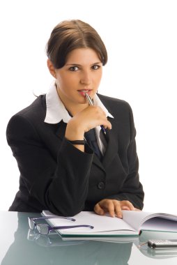 a young woman in black jacket and white shirt and a tie sitting down behind an office table and playing with glasses clipart