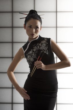 Oriental girl with chopstick