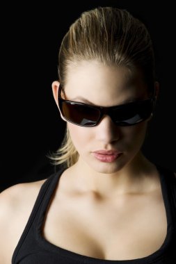 glamor portrait of a blond mistery woman with sunglasses looking down clipart