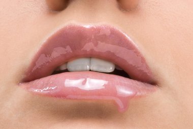 clse up of a red mouth with lipstick and lip gloss dropping down clipart