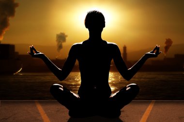 silhouette of woman in a sunset relaxing her mind with yoga near sea port with industry clipart