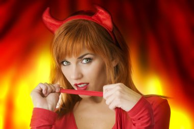 close up poertrait of a red haired girl with horns like a devil looking in camera clipart