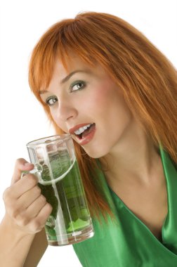 close up of young pretty woman with a glass of green beer clipart