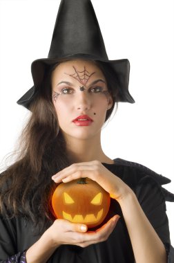 cute girl with witch hat and a little pumpkin betweeen hands clipart