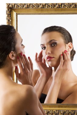 beauty portrait of young woman looking in camera from the mirror clipart