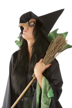 profile of old ugly witch with big nose and glasses arming a broom clipart