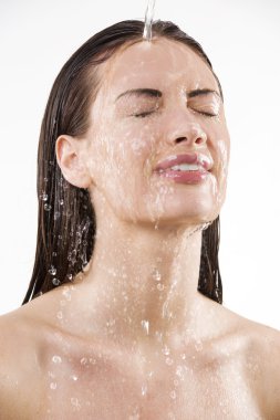 close up portrait of a pretty young woman getting some fresh water falling down from top clipart