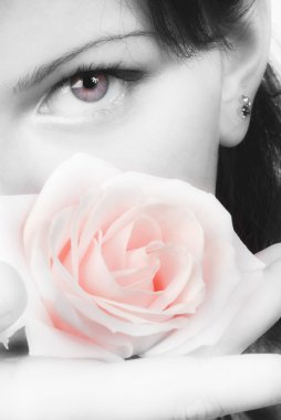 nice black and white portrait of a young woman with roses in her hands smelling and smiling with her fair eyes clipart