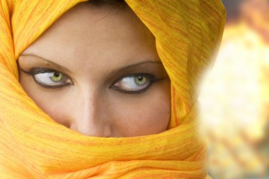 attactive and strong eyes behind an orange scarf used like a burka clipart