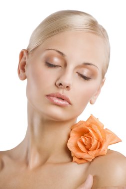 beauty sweet portrait of a blond pretty woman with an orange wet flower on shoulder relaxing with closed eyes clipart