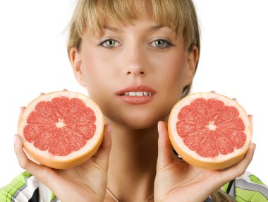 close up of blond girl with two half grapefruit in her hands clipart