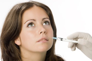 Portrait of fresh and beautiful woman getting botox injection clipart
