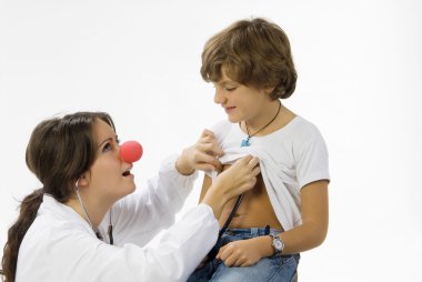 young and cute female doctor with a red nose visiting a little boy clipart