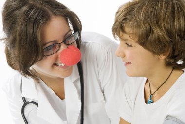 young and cute female doctor with a red nose visiting a little boy clipart