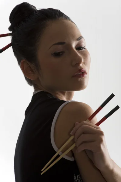 Oriental girl with chopstick — Stockfoto