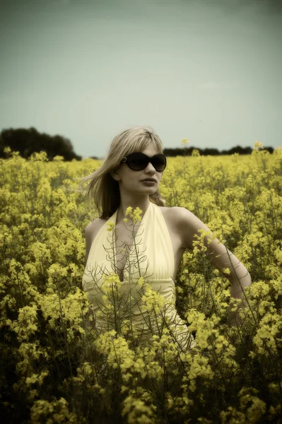 かわいい若いブロンドの女性屋外太陽めがねをかけて Falsed 色と黄色のフィールドでの肖像画 — ストック写真