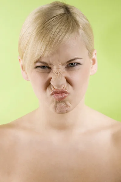 Young Woman Wtih Yellow Top Green Background Making Funny Face — 스톡 사진