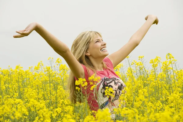 Happy girl in yellow field Stock Photo