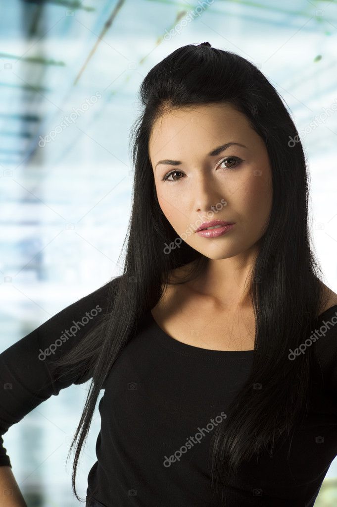 studio shot of graceful asian girl in black dress with dark hair