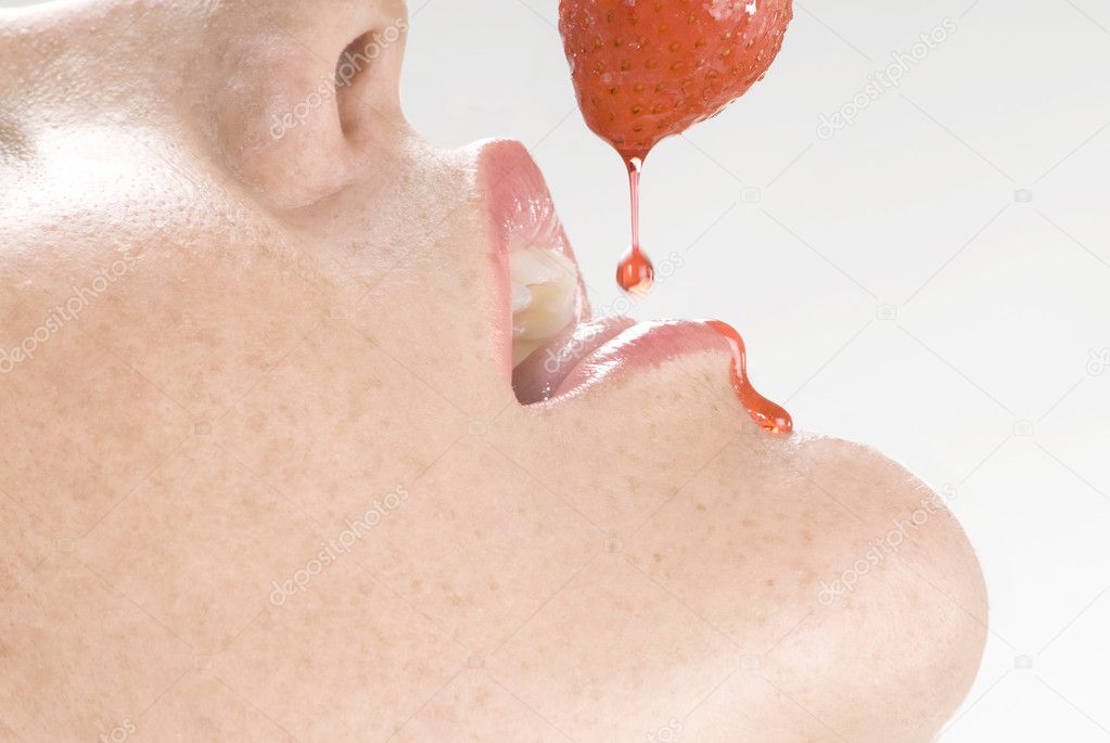 strawberry dropping its juice inside a woman mouth