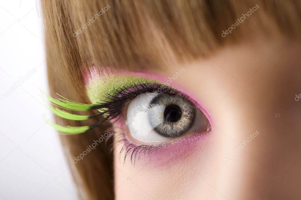 eye lloking in camera with colored make up and long eyelashes