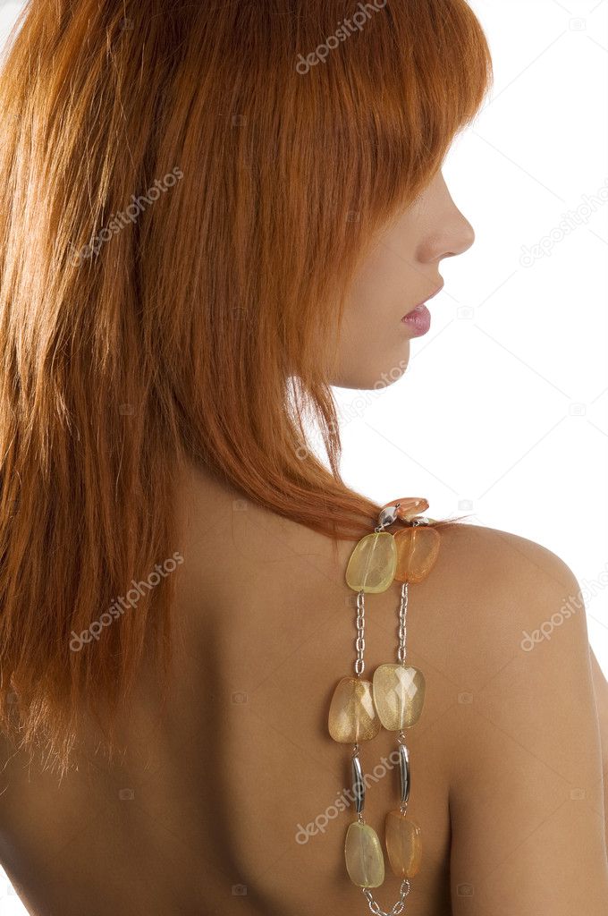 back side shot of young and beautiful red haired with stones necklace on shoulder